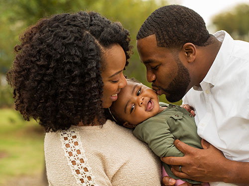 Parents after emotion focused caregiver workshop kissing baby